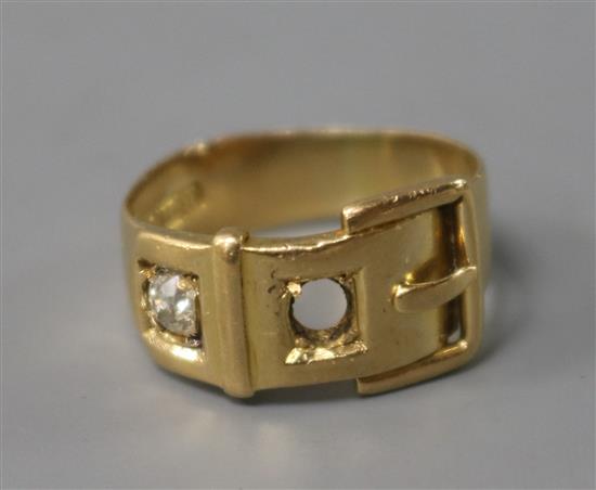 An early 20th century 18ct gold, ruby and diamond set buckle ring, size K.